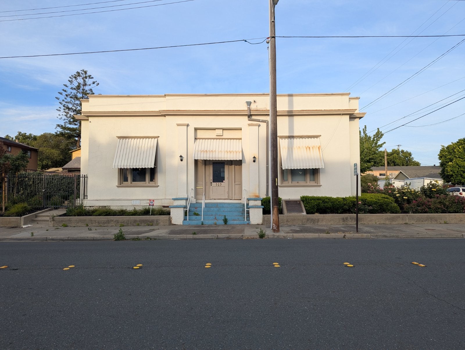 Historic Carnegie Library building on a residential street in downtown Antioch, California, with the painted curb where Halo confirms the legal truck position