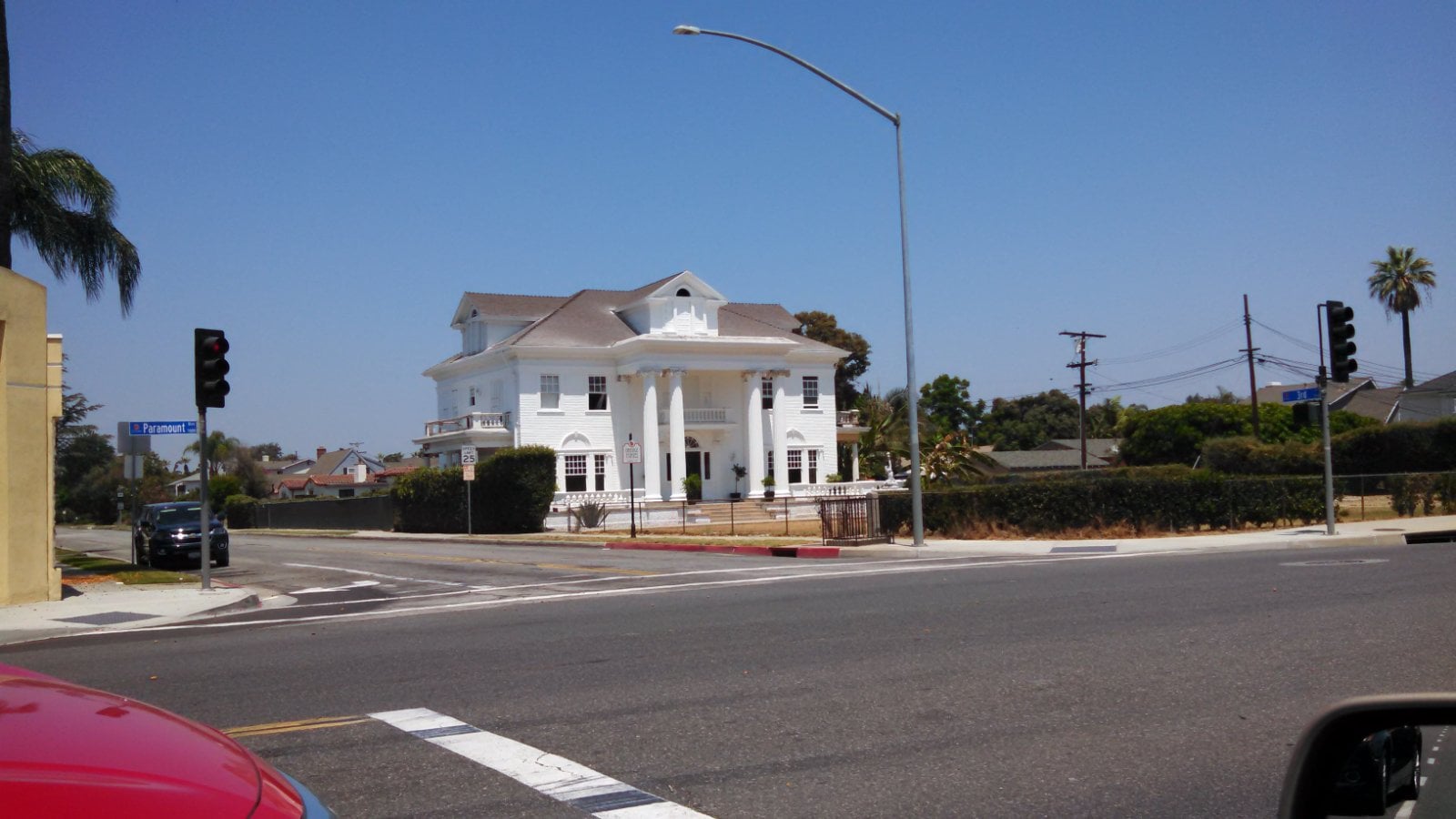 Large single-family home on a corner street in the Orange Estates area of Downey, California, where California Movers USA verifies the driveway and legal truck position