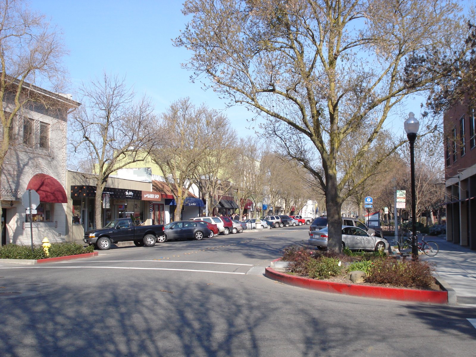 Street with parked cars and shopfronts in downtown Davis, California, where Halo reviews the block and records the legal loading position