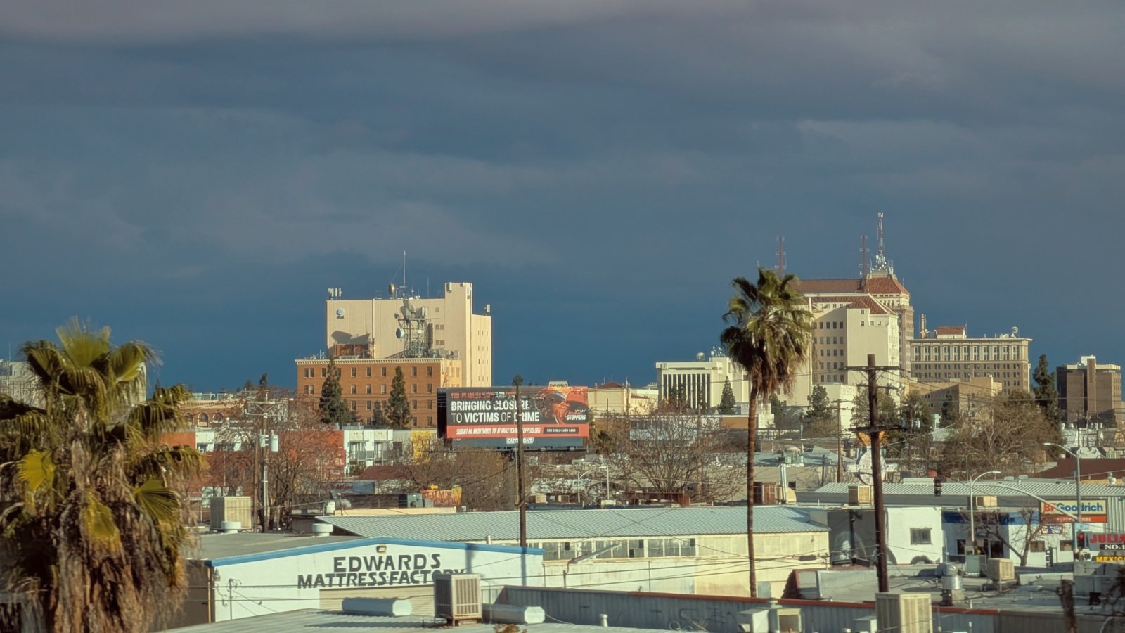 View across downtown Fresno, California, with low-rise buildings and palm trees where California Movers USA confirms the curb position and move window