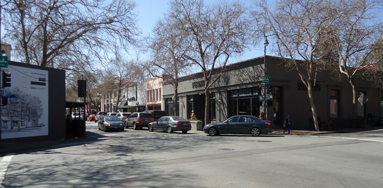 Downtown Palo Alto, California street with metered curb parking and shopfronts where Halo California Movers checks the legal truck position before loading