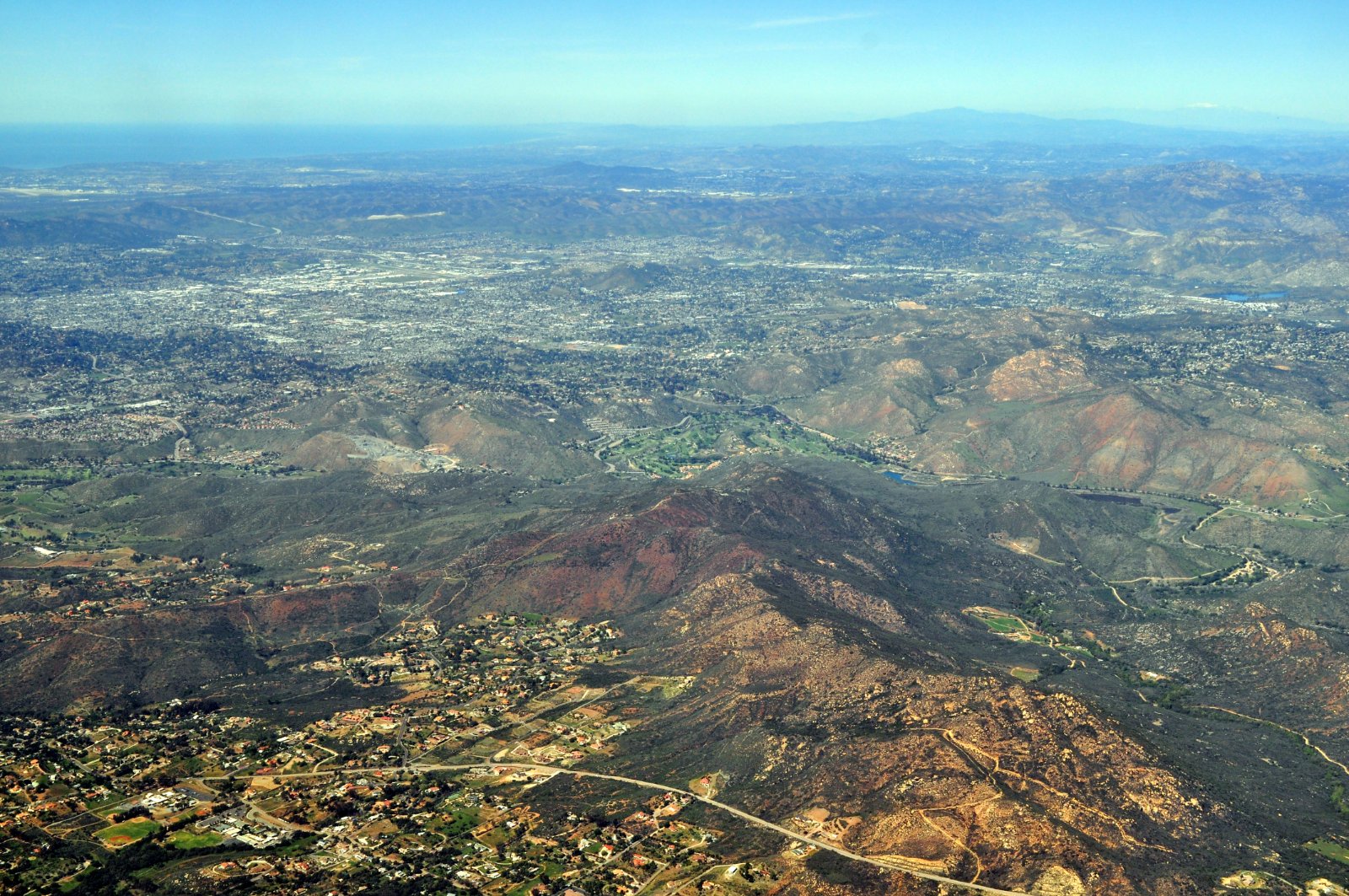 Aerial view of the El Cajon valley and surrounding hills in California, where California Movers USA reviews grade and truck clearance before a hillside move