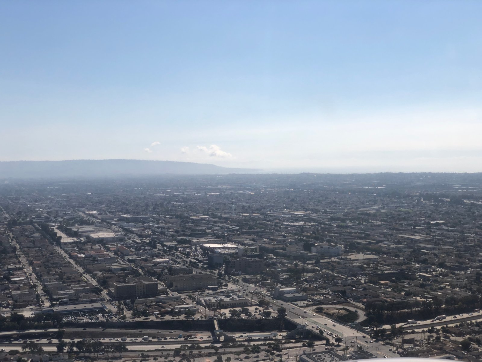 Aerial view southwest across the compact street grid of Hawthorne, California, where California Movers USA confirms the legal truck position and alley access