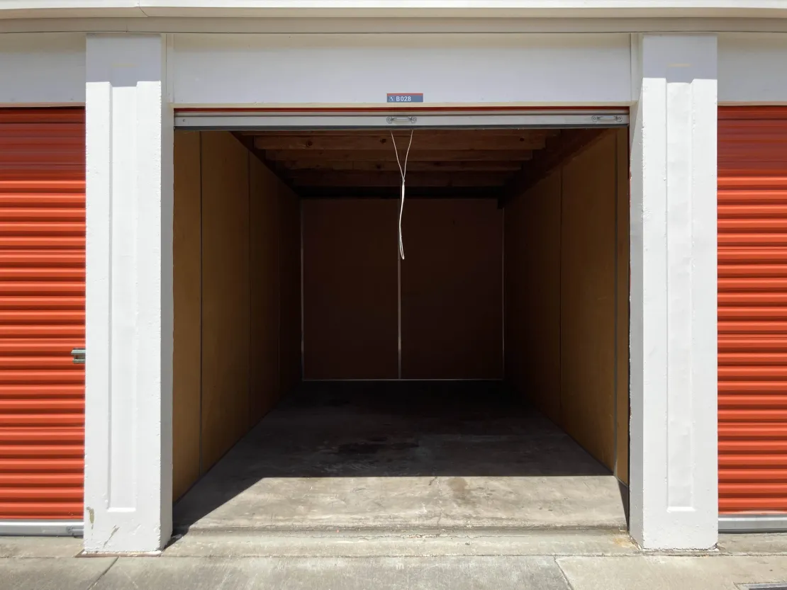 Open self-storage unit standing empty, the option most people compare against storage in transit during a move